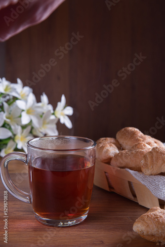 cup with tea and croissants, breakfast in the morning.
