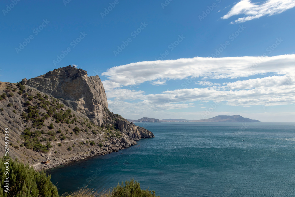 Scenic view of the sea and cape against a clear blue sky