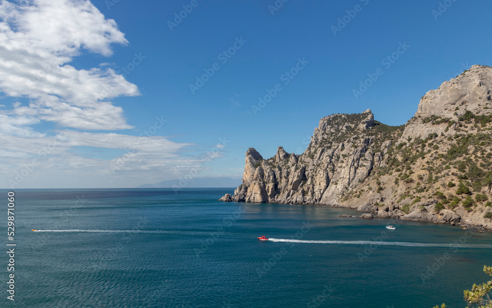 Scenic view of the sea and cape against a clear blue sky