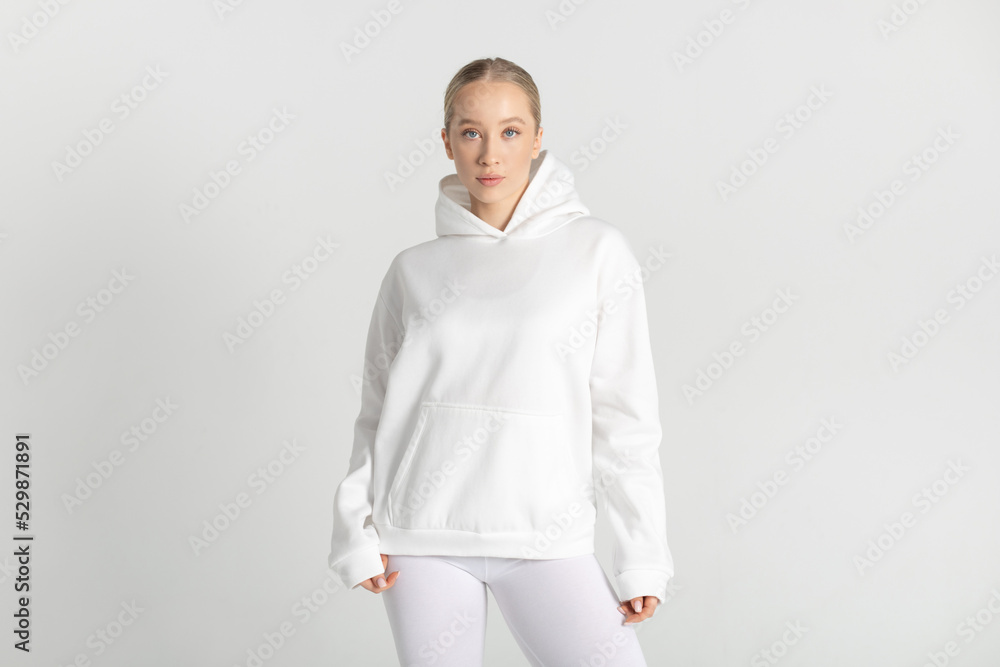Athletic woman in white hoodie and leggings. Mock-up. Athletic woman in white hoodie and leggings. Mock-up.