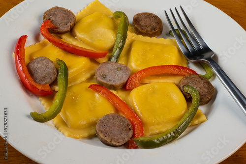 four cheese ravioli  with sweet italain sausage  and peppers photo