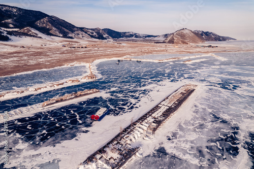 Bilde på lerret Travel winter lake Baikal, clear ice surface with mountains and tourists