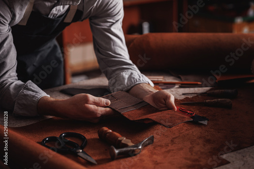 Schilderij op canvas Handicraft production, Craft man tailor checks handmade brown leather product