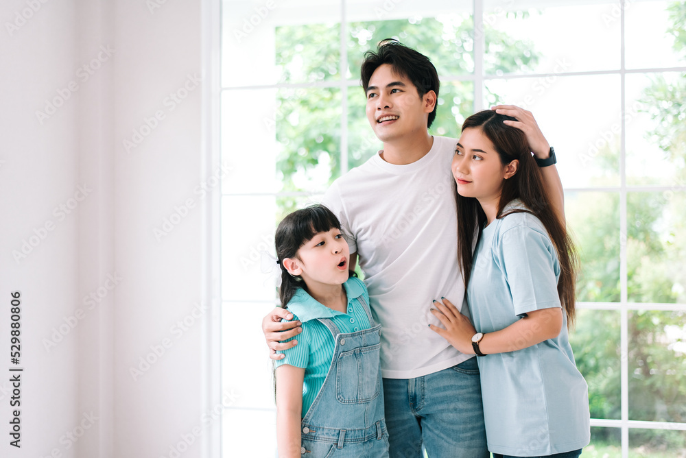 Portrait of young happy asian family spending time together at living room.