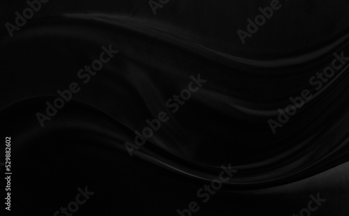 Black gray satin dark fabric texture luxurious shiny that is abstract silk cloth background with patterns soft waves blur beautiful.