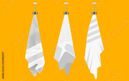 three light towels are hung on three old hangers