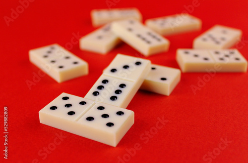 White dominoes randomly arranged on a red background