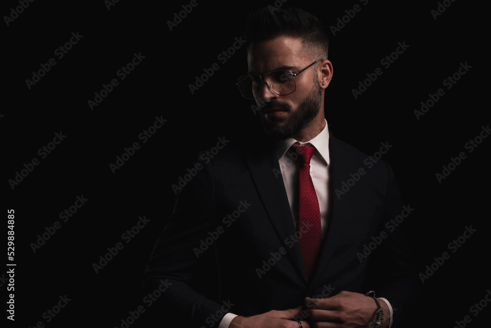 bearded businessman with glasses unbuttoning black suit bearded businessman with glasses unbuttoning black suit