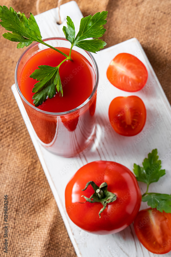Dietary tomato juice on linen background. Healthy drink made from farm vegetables. Dietary tomato juice on linen background. Healthy drink made from farm vegetables.