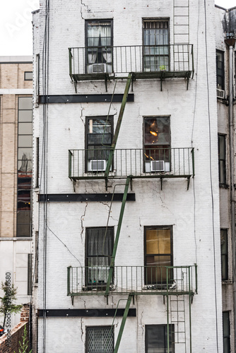 Old New York apartment building with fancy terra cotta detailing Manhattan Lower East Side apartment building with external fire ladders
