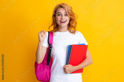 Portrait of smiling female student with books. Happy girl with a backpack. Beautiful woman hold study applies back bag.