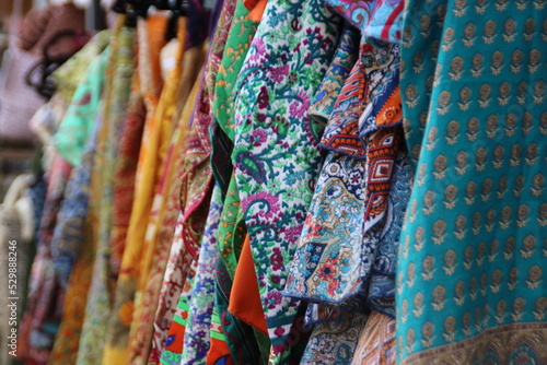 Fashion textile coloured clothes hanging on a boutique