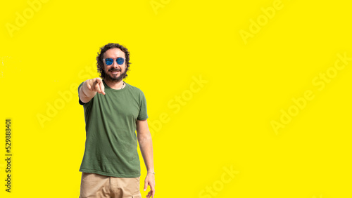 Man pointing with yellow background