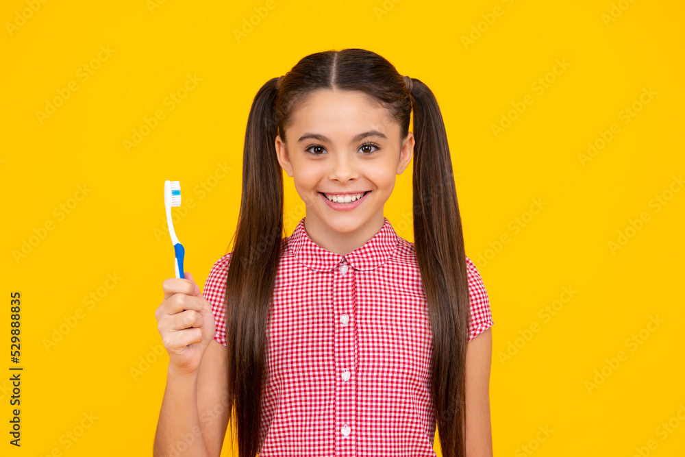 Teen girl hold toothbrush, childhood happiness, morning routine. Brush teeth, dental health and oral care. Child brush her teeth. Happy teenager, positive and smiling emotions of teen girl. Teen girl hold toothbrush, childhood happiness, morning routine. Brush teeth, dental health and oral care. Child brush her teeth. Happy teenager, positive and smiling emotions of teen girl.