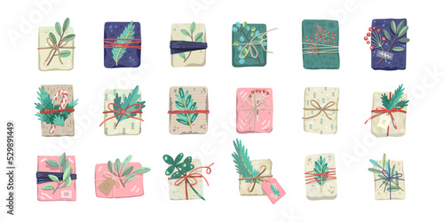 Set of Christmas gifts, decorated with plants, ribbons and recycled wrapping paper