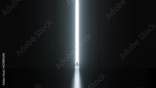A large shining door opens in the dark. Small man and big world.