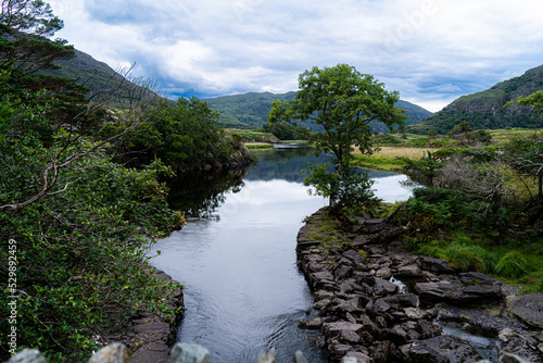 Meeting of the Waters, Killarney.  the best hidden gem. This is the point where all of Killarney’s three glorious lakes merge together, the upper lake, Muckross Lake and Lough Leane. Old Weir Bridge. photo