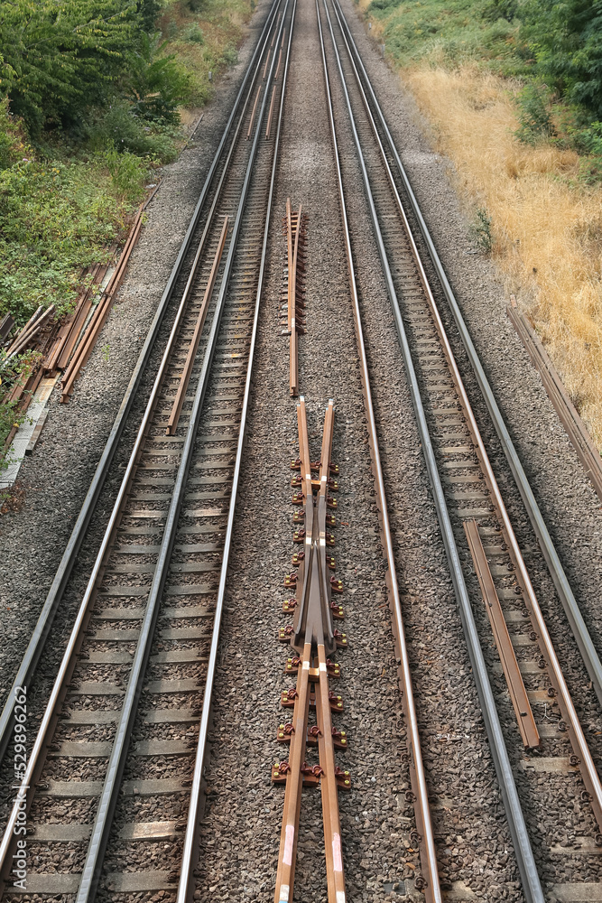Railway tracks laid outside the city. A vertical image. Railway tracks laid outside the city. A vertical image.
