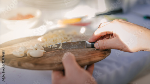 Close up photo of male hands is preparing wonderful fresh salad. Chef cooking food cutting prepare hands knife preparing vegetables.