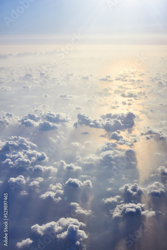 a view from an airplane of clouds over the sea at sunset or sunrise