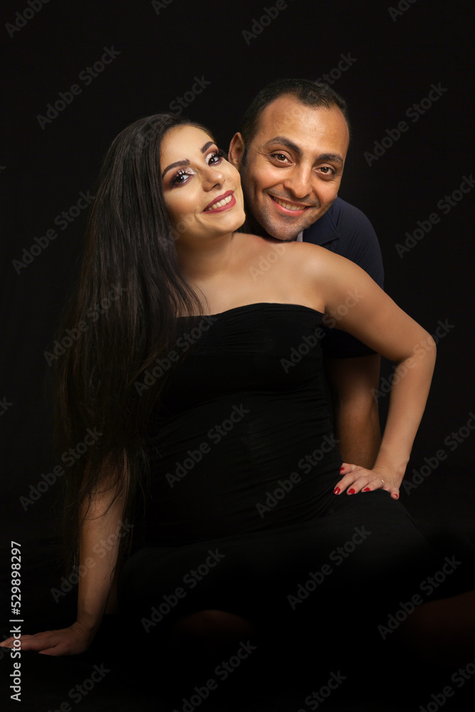 Portrait of a young couple waiting for a baby. Taken in a photo Studio on a black background. High quality photo Portrait of a young couple waiting for a baby. Taken in a photo Studio on a black background. High quality photo