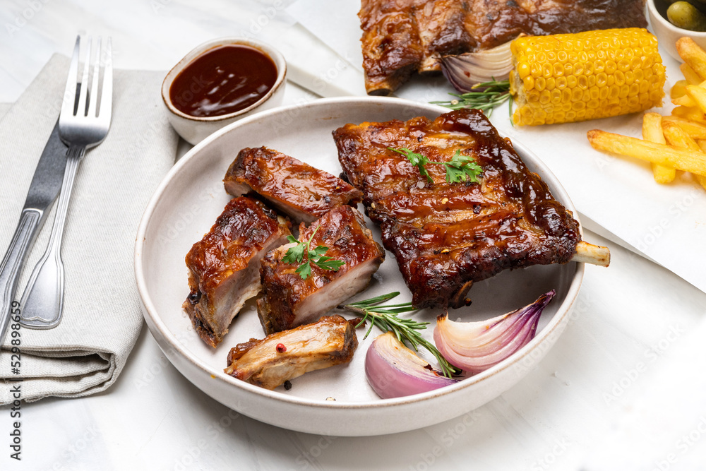 Grilled pork ribs with barbecue sauce and grilled vegetables. top view Grilled pork ribs with barbecue sauce and grilled vegetables. top view