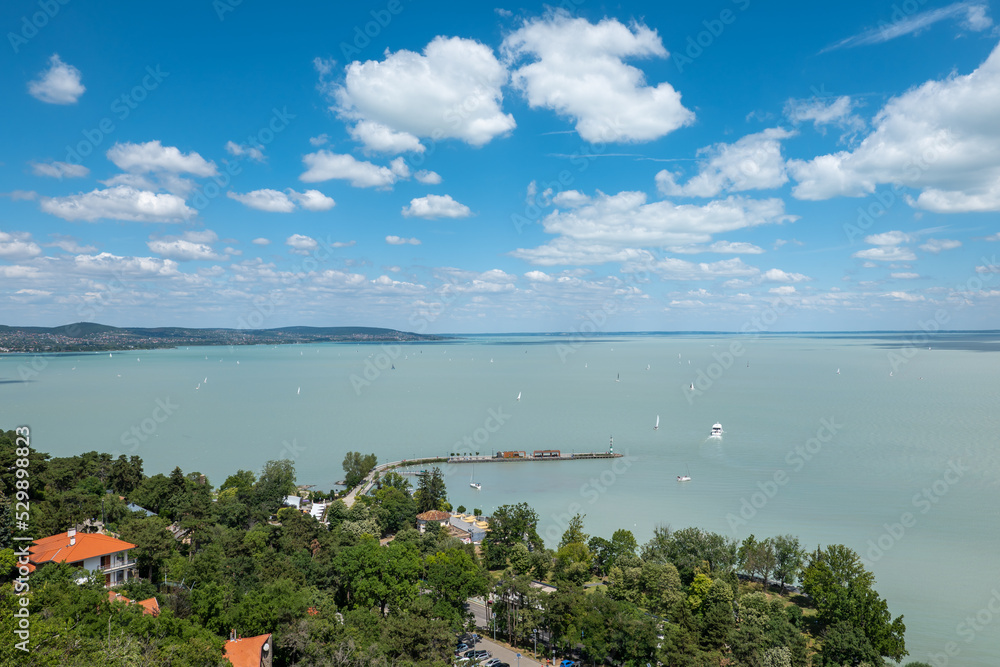 View of Balaton lake on a sunny day with blue sky and clouds, view from Tihany village, Hungary