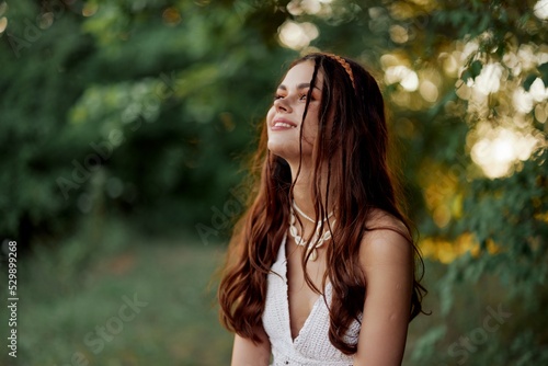 A woman dressed as a hippie with pigtails on her head travels outdoors at a campground in the fall and enjoys life