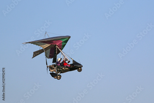 Valokuva Ultralight airplane flying in a blue sky