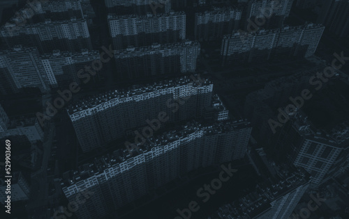 De-energized residential buildings of the metropolis. Dark streets of a de-energized metropolis. Only moonlight. Drone view