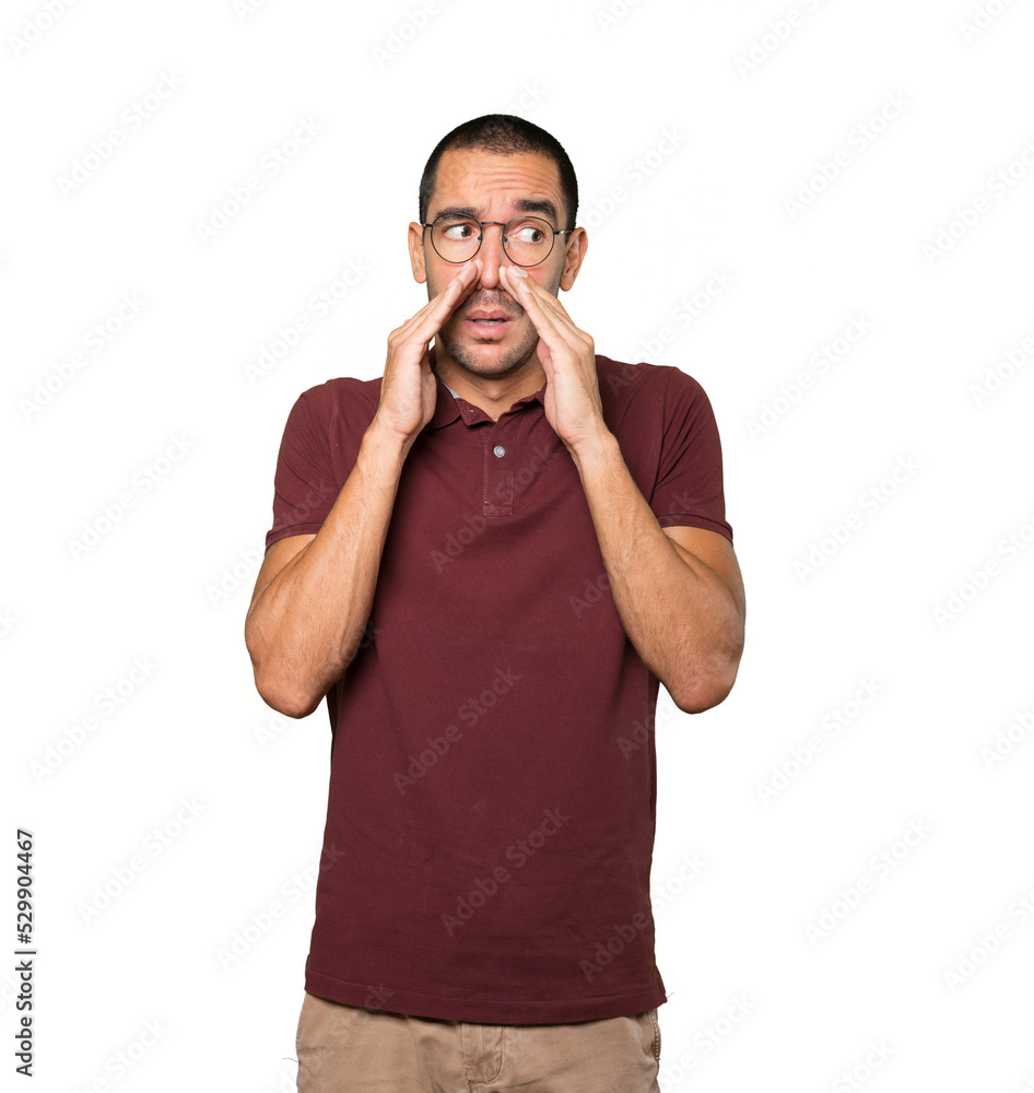 Concerned young man with a gesture of disgust Concerned young man with a gesture of disgust