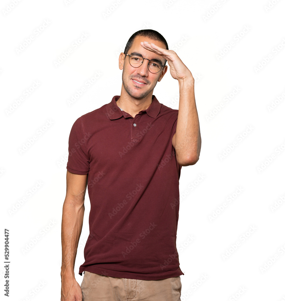 Happy young man with a gesture of looking away Happy young man with a gesture of looking away