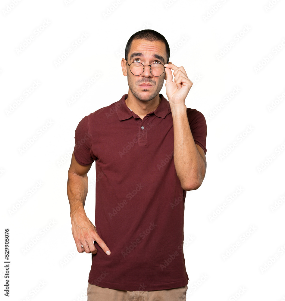 Serious young man looking against background Serious young man looking against background
