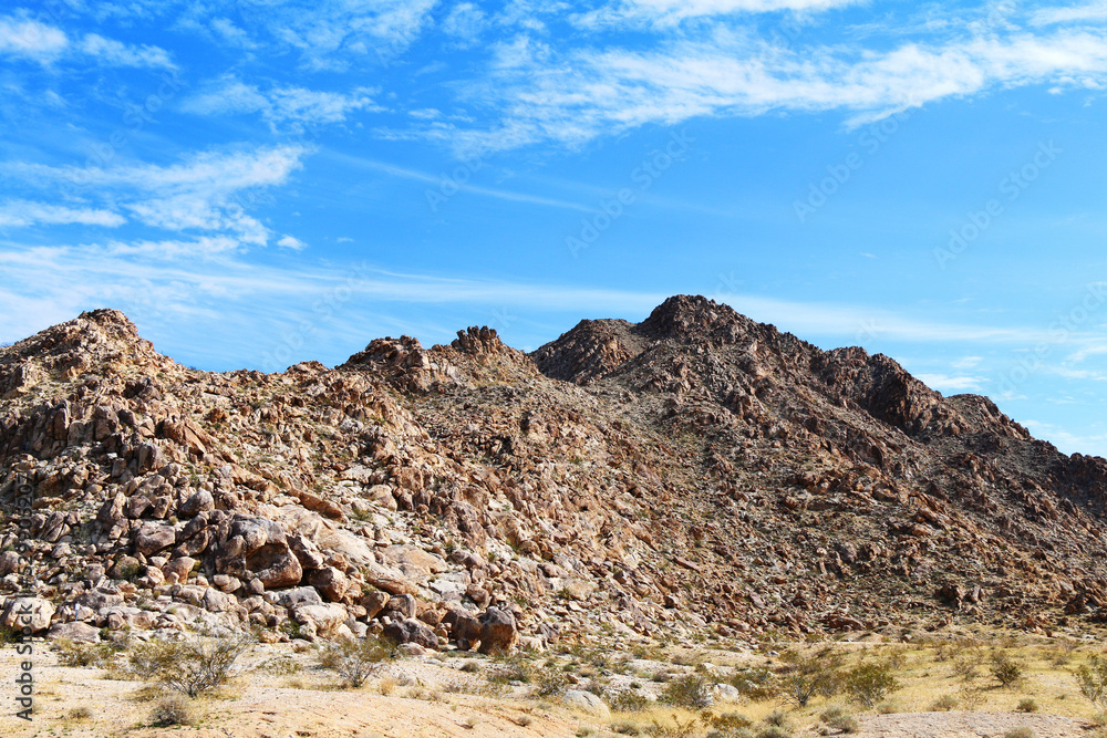 Fototapeta premium rock desert mountain terrain landscape blue sky hiking trail adventure area clouds weather overcast