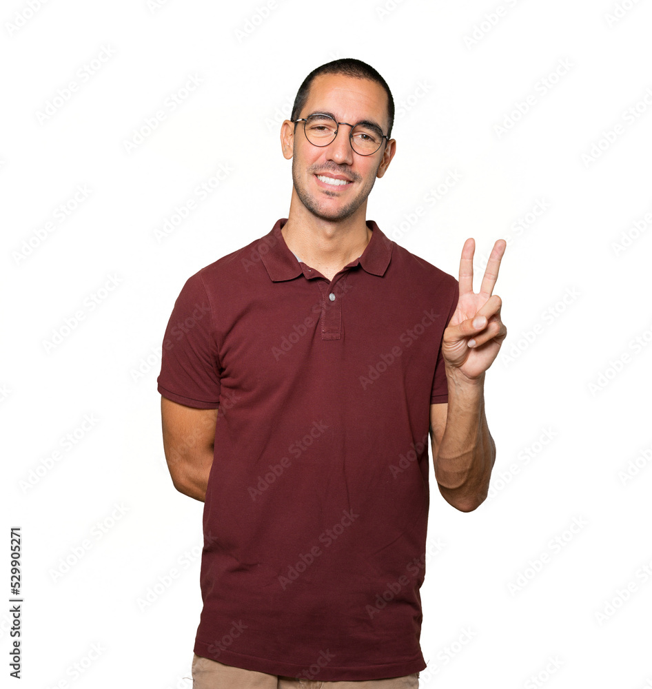 Young man making a number two gesture Young man making a number two gesture