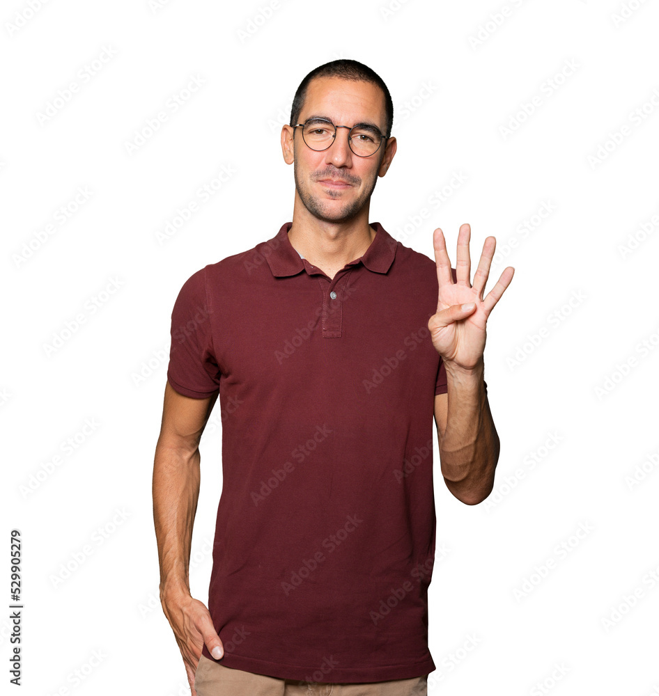 Young man making a number four gesture Young man making a number four gesture