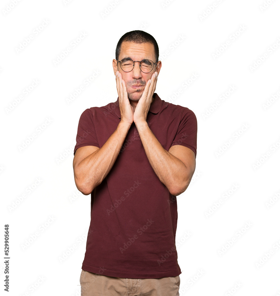 Concerned young man doing a gesture of relief Concerned young man doing a gesture of relief