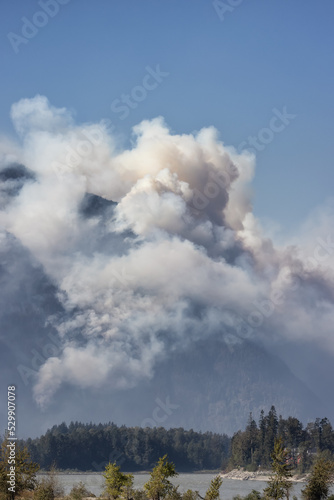BC Forest Fire and Smoke over the mountain near Hope during a hot sunny summer day. British Columbia, Canada. Wildfire natural disaster