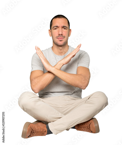 Young man making a gesture of not crossing with the arms photo