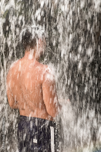 A man standing under a waterfall in Morocco photo