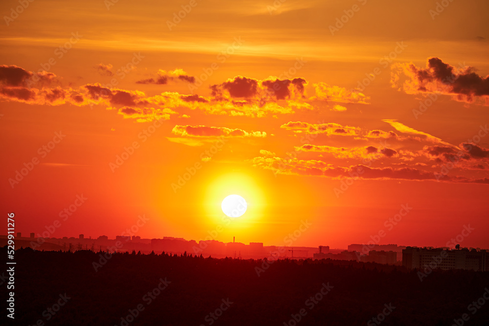 Evening sky with setting sun through clouds at sunset, cloudy landscape
