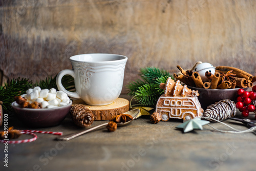 Christmas holiday decorations near mug with hot chocolate photo
