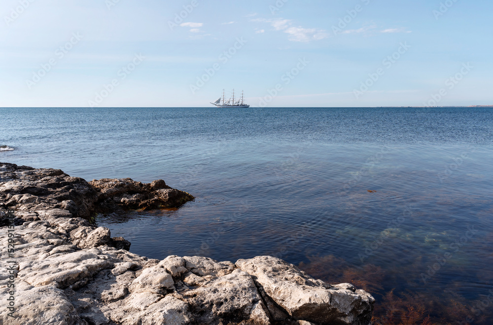 Beautiful seascape with sailing ship on the horizon on sunny day. Great design for any purposes. Beautiful summer landscape. Natural background. Copy space. Wallpaper design.