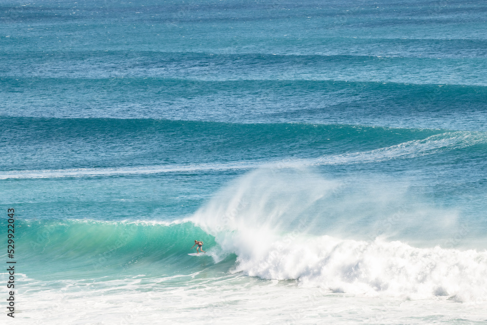 A surfer riding a wave on a long barrel on the Gold Coast
