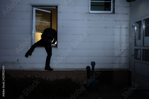 Burglar Entering In A House Through A Window