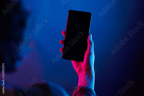 Night life mobile phone over the shoulder