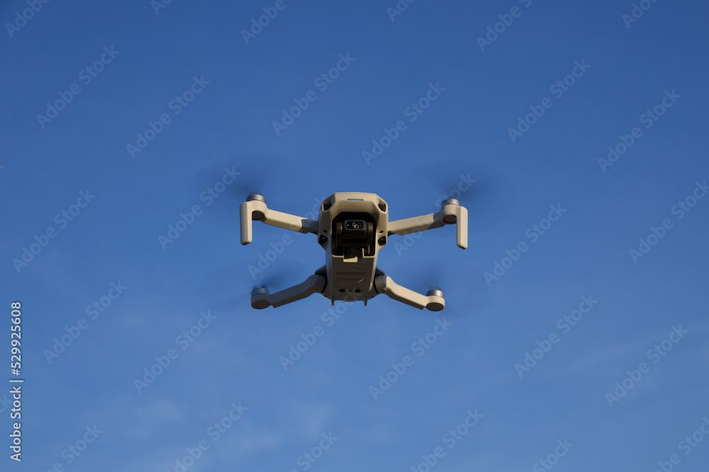 A small drone hovering in the air. A small drone hovering in the air.