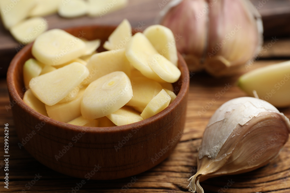 Fresh chopped garlic in bowl on wooden table, closeup. Organic product Fresh chopped garlic in bowl on wooden table, closeup. Organic product
