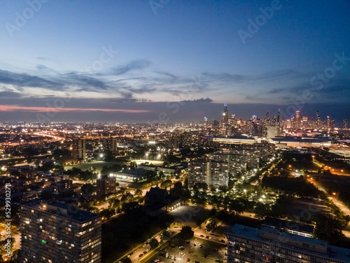 establishing aerial drone night time view of the Chicago skyline metropolis. the cityscape has beautiful architecture that tourist can sightsee.