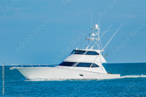 A sportfish motor yacht heads out to sea for a fishing trip